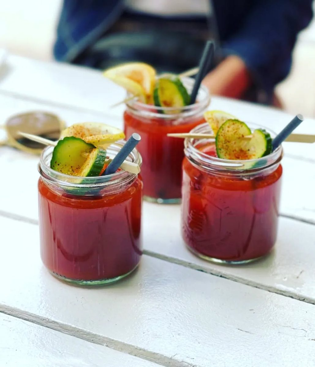 Two Bloody Marys in jars with cucumber and lemon